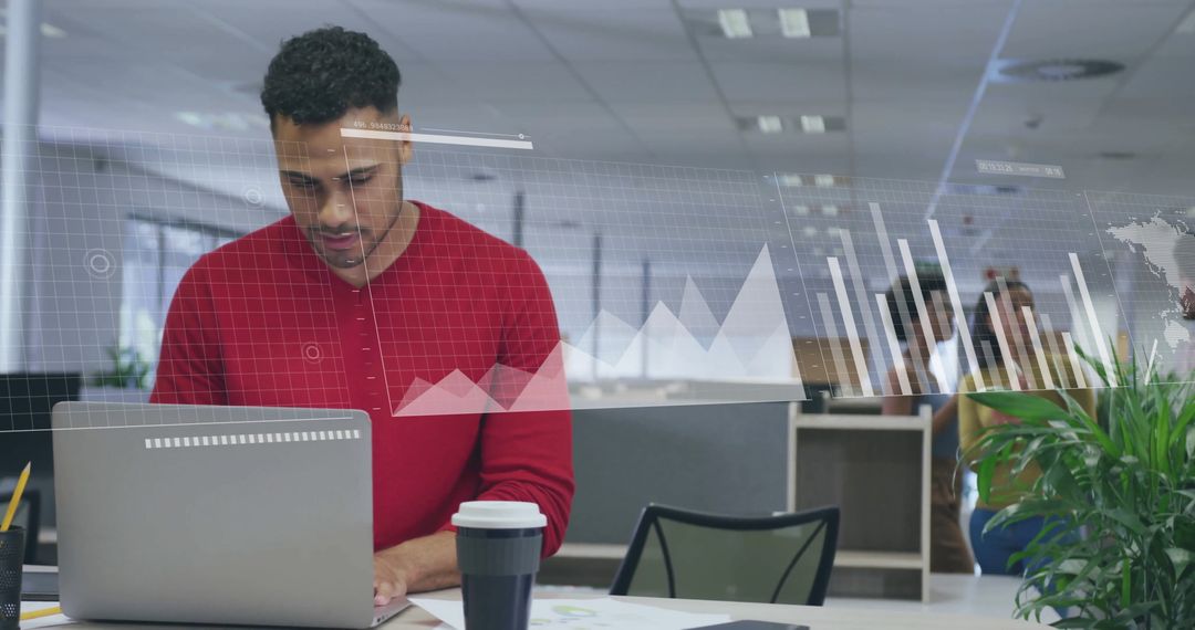 Businessman Analyzing Financial Data with Laptop in Modern Office