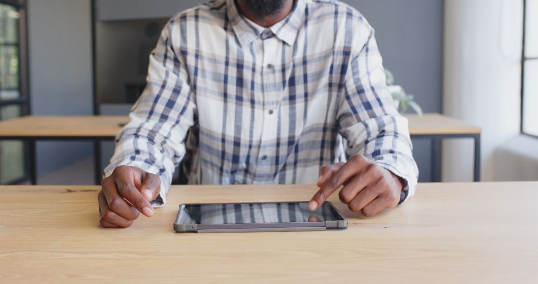 Businessman Utilizing Tablet Technology in Modern Office Setting