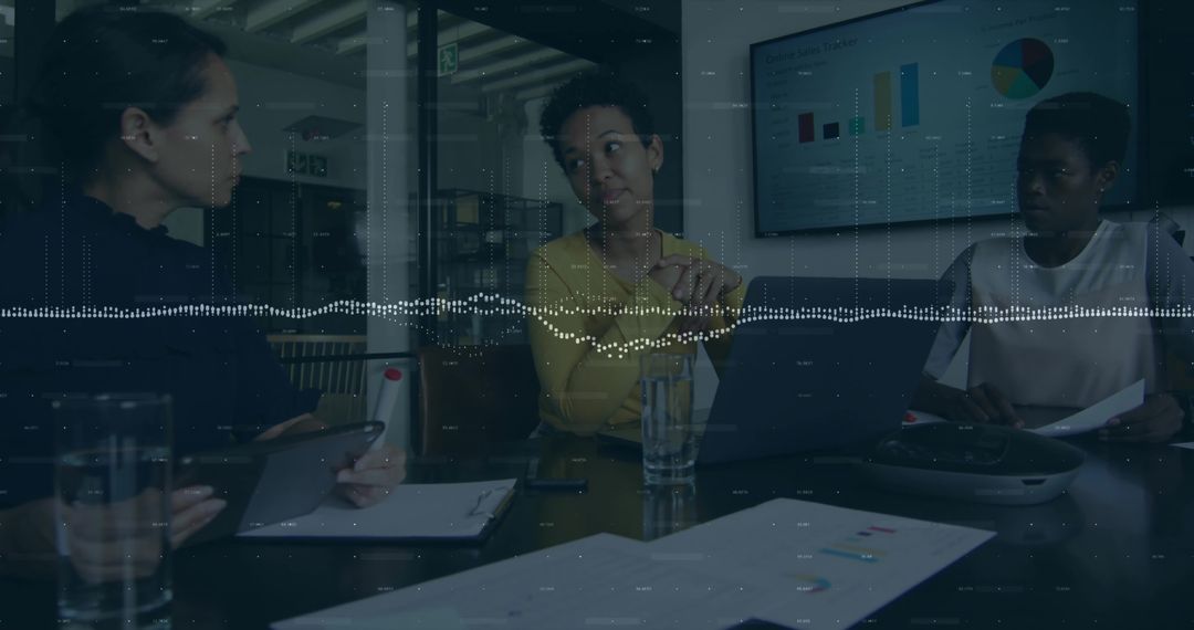 Diverse Businesswomen Discussing Data Insights in Modern Office