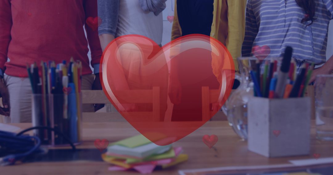 Group Collaboration Around Creative Workspace with Heart Icon