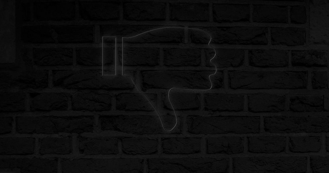 Glowing Neon Thumb Down on Brick Wall