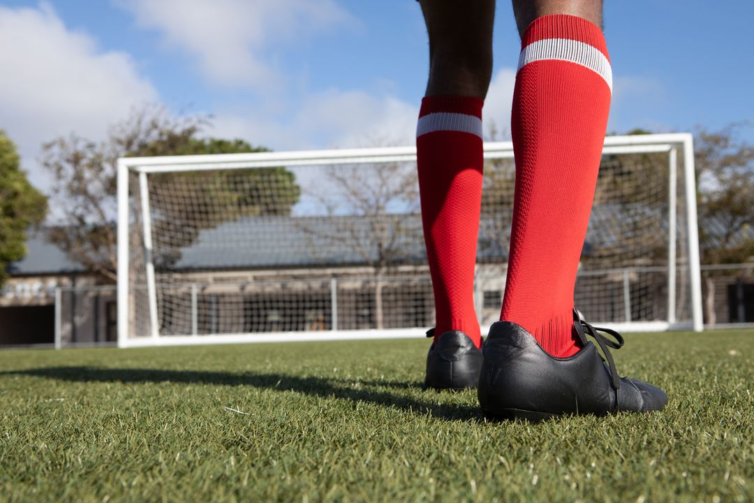 Athlete Preparing for Kick Facing Goal on Sunny Football Field