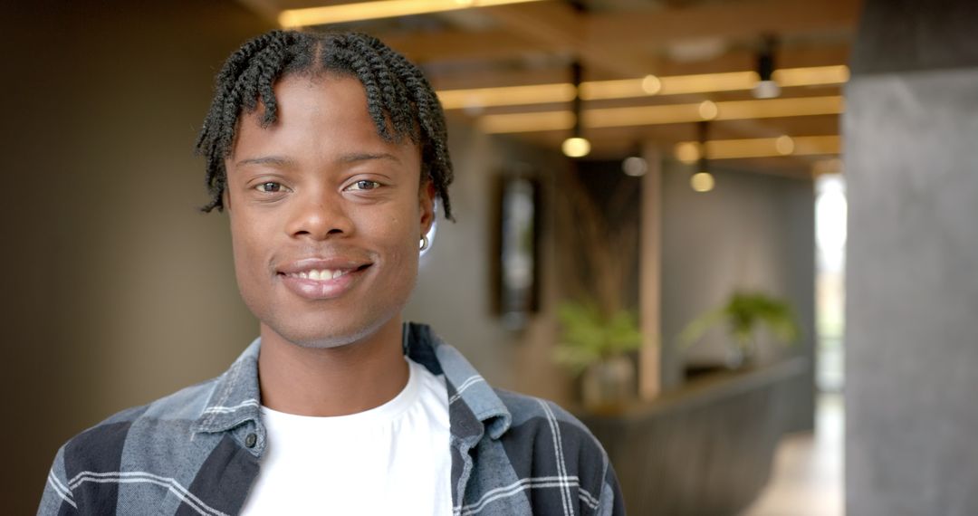 Smiling Young Man in Modern Office Setting
