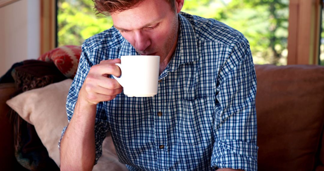 Man Enjoying Morning Coffee in Cozy Living Room - Free Images, Stock Photos and Pictures on Pikwizard.com