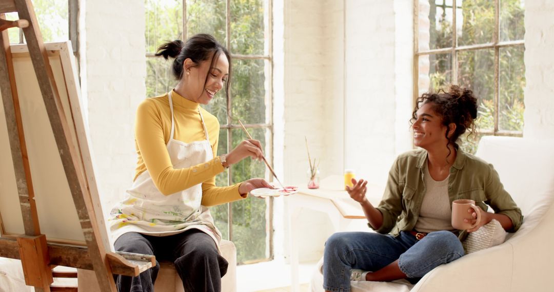 Creative Women Relaxing with Art in Bright Studio