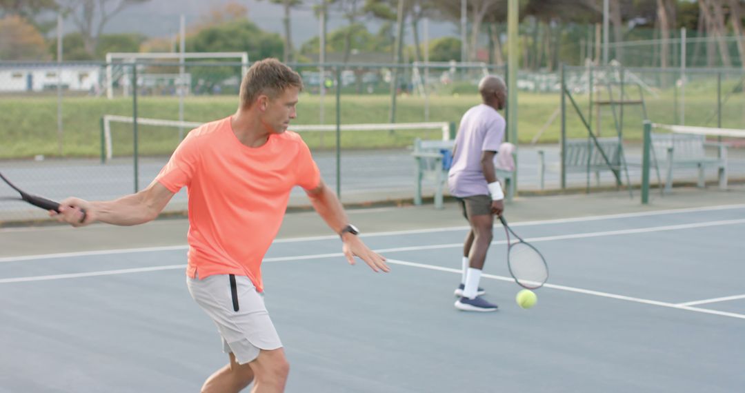 Tennis Practice on Sunny Outdoor Court with Diverse Athletes - Free Images, Stock Photos and Pictures on Pikwizard.com