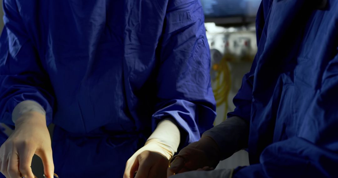 Surgeons in blue scrubs performing surgery in operating room - Free Images, Stock Photos and Pictures on Pikwizard.com