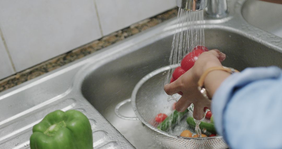 Woman Rinsing Fresh Vegetables in Kitchen Sink for Meal Preparation - Free Images, Stock Photos and Pictures on Pikwizard.com