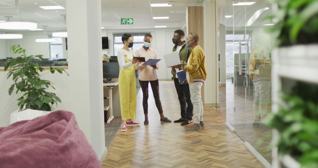 Diverse Professionals Collaborating in Modern Office with Face Masks