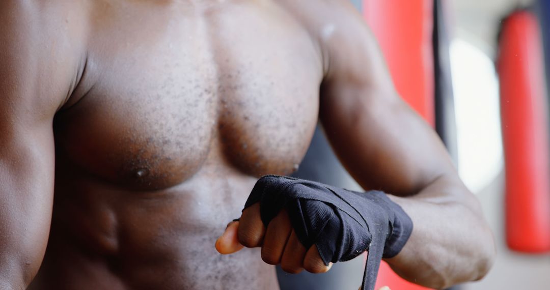 A muscular African American man prepares for exercise, embodying fitness commitment. - Free Images, Stock Photos and Pictures on Pikwizard.com