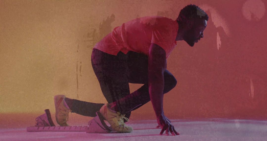 Poising Sprinter on Starting Blocks under Neon Magenta Orange Studio Lighting