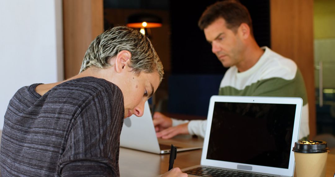 Two Professionals Working in Open Office Concept for Collaborative Projects