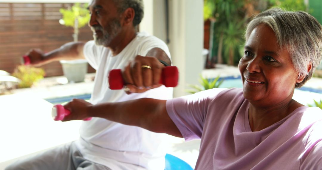 Active Senior Couple Enjoying Workout with Dumbbells in Bright Home