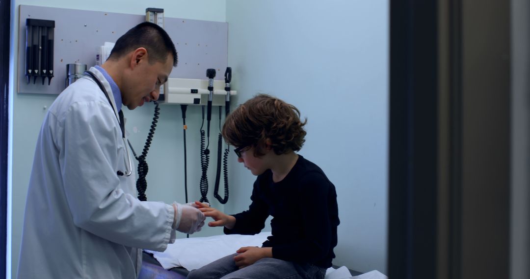 Doctor Examining Young Boy in Clinic - Free Images, Stock Photos and Pictures on Pikwizard.com