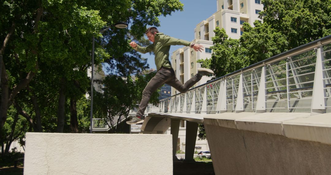 Freerunner Taking Leap from Urban Bridge in Vibrant Cityscape - Free Images, Stock Photos and Pictures on Pikwizard.com