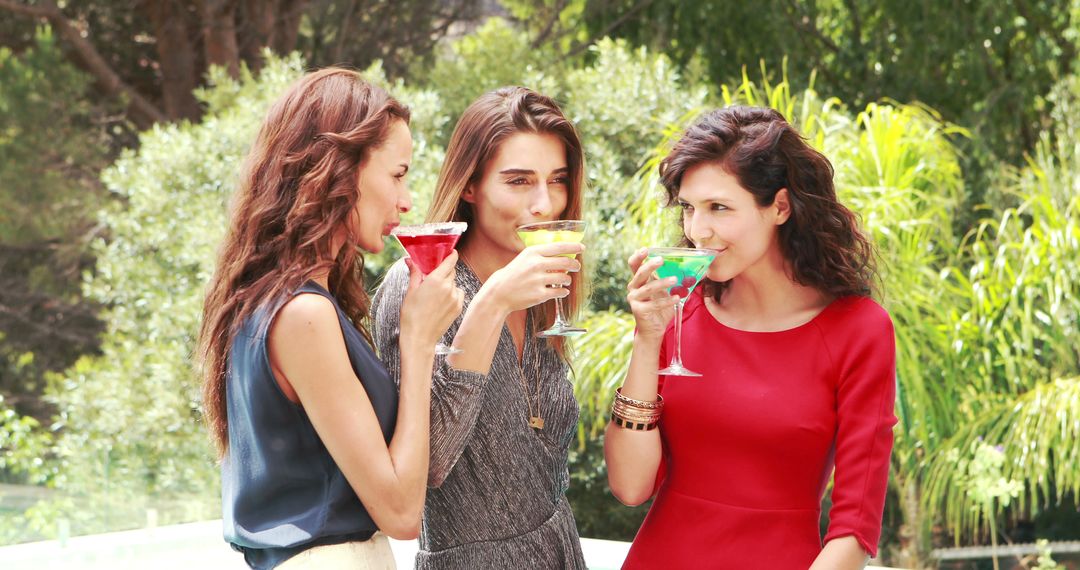 Group of Young Women Enjoying Colorful Cocktails Outdoors - Free Images, Stock Photos and Pictures on Pikwizard.com