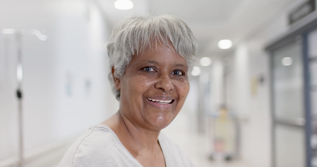 Senior African American Woman Smiling in Hospital Corridor - Free Images, Stock Photos and Pictures on Pikwizard.com