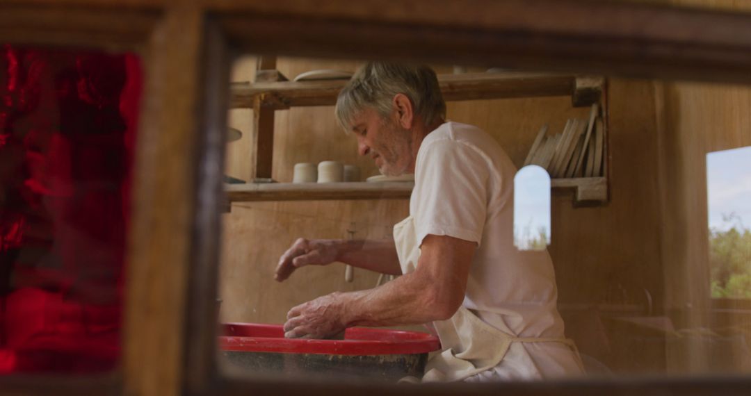 Senior Artisan Making Pottery in Workshop, Embracing Creativity and Tradition