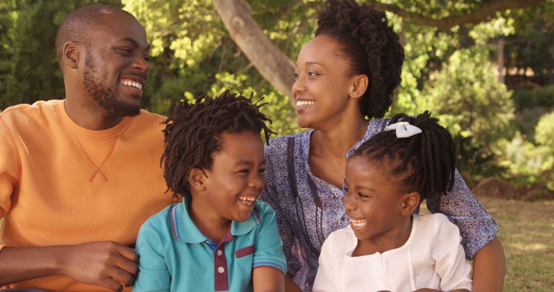 African American Family Smiling and Laughing Together Outdoors - Free Images, Stock Photos and Pictures on Pikwizard.com