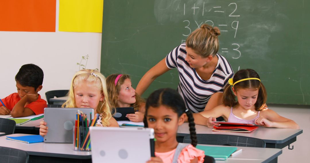 Teacher Helping Students Using Tablets in Classroom - Free Images, Stock Photos and Pictures on Pikwizard.com