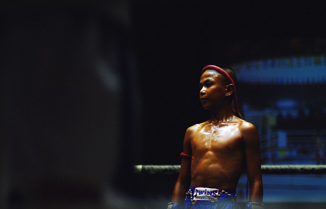 Young Muay Thai Fighter Preparing for Match in Boxing Ring - Free Images, Stock Photos and Pictures on Pikwizard.com