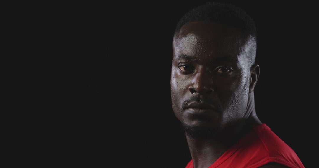 Portrait of Determined African American Man in Red Shirt on Black Background - Free Images, Stock Photos and Pictures on Pikwizard.com