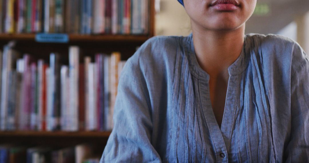 Young Woman Studying in Library Wearing Blue Shirt - Free Images, Stock Photos and Pictures on Pikwizard.com