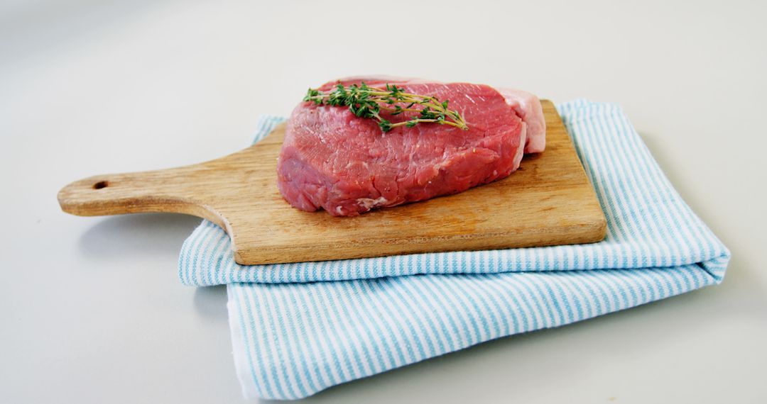 Raw Steak on Wooden Cutting Board with Fresh Herbs - Free Images, Stock Photos and Pictures on Pikwizard.com