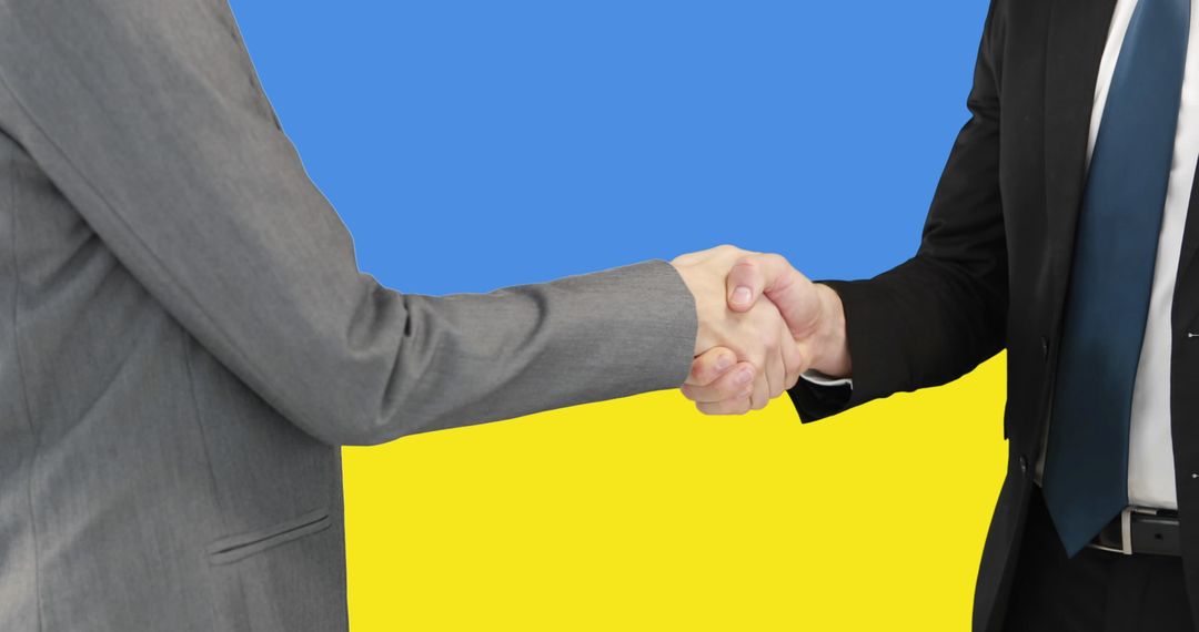 Business Handshake Over Ukraine Flag Represents International Cooperation