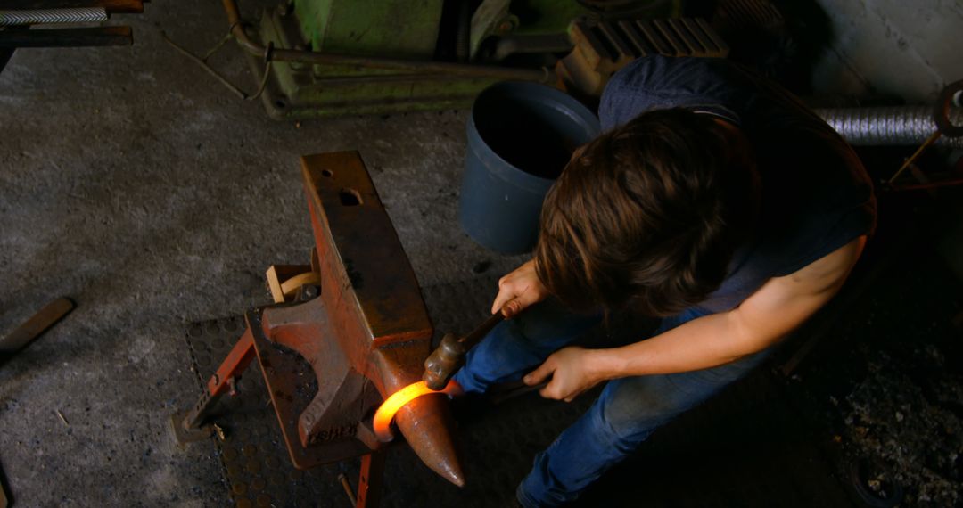 Blacksmith Hammering Red-Hot Metal Rod on Anvil - Free Images, Stock Photos and Pictures on Pikwizard.com