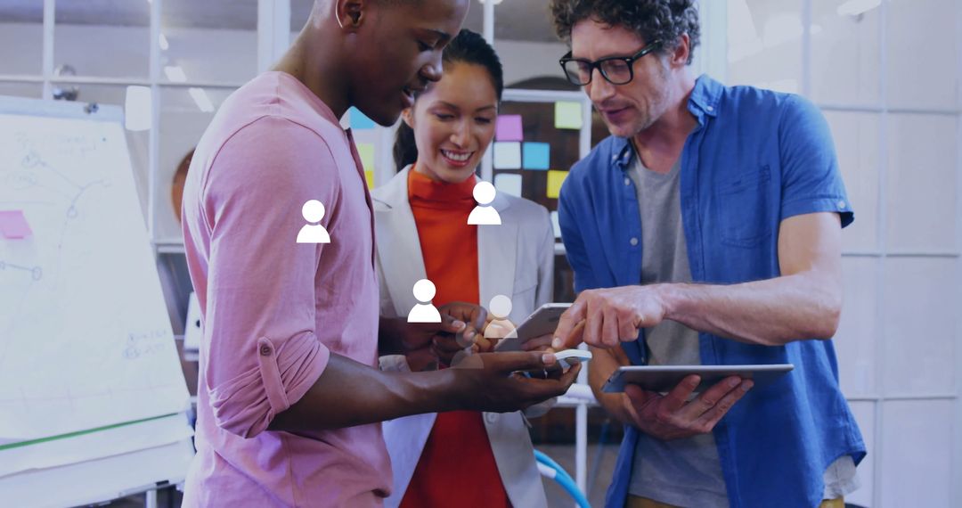 Diverse Coworkers in Office Collaborating with Smartphone and Tablet