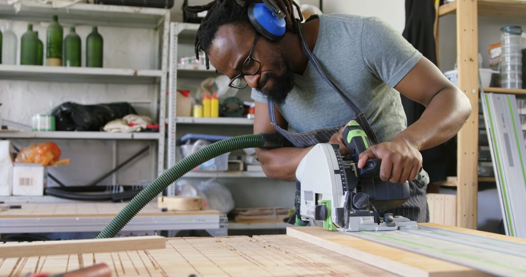 Man Using Circular Saw in Woodworking Workshop - Free Images, Stock Photos and Pictures on Pikwizard.com