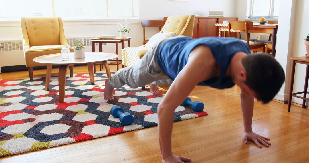 Man Doing Push-Ups at Home in Living Room with Colorful Rug - Free Images, Stock Photos and Pictures on Pikwizard.com