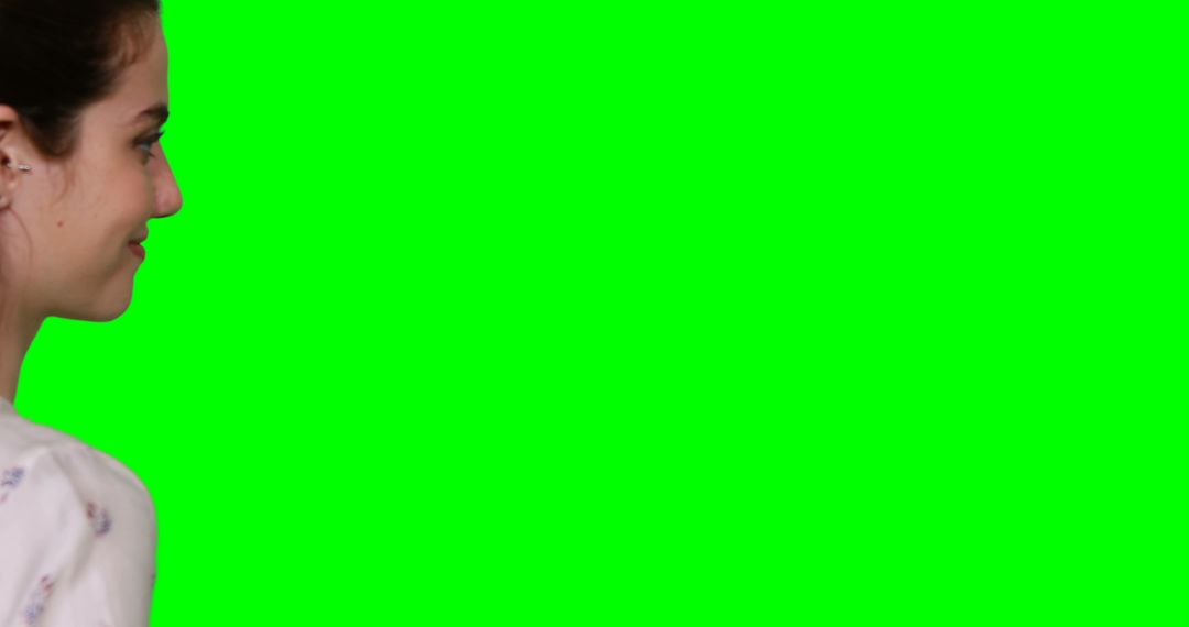 Woman Pretending to Interact with Virtual Interface on Green Screen