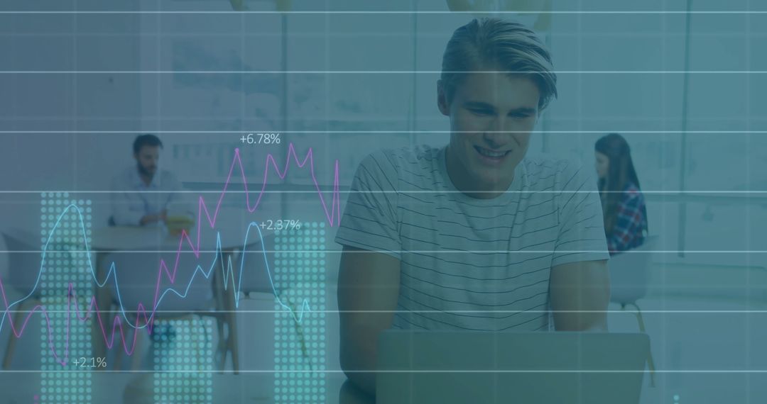Young Man Analyzing Data on Laptop with Overlaid Financial Graphics