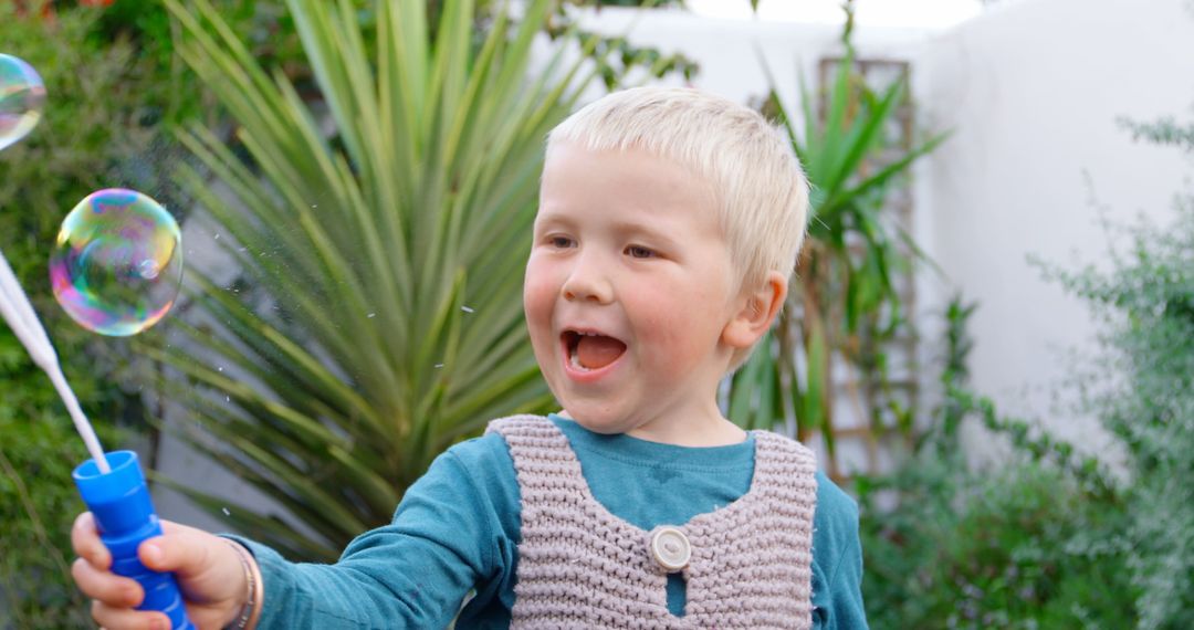 Delighted Boy Chasing Bubbles in Lush Garden