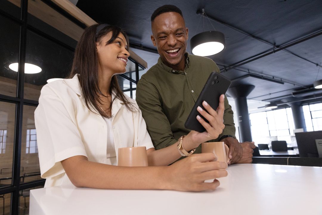 Diverse Team Collaborating in Modern Office with Smartphone Technology