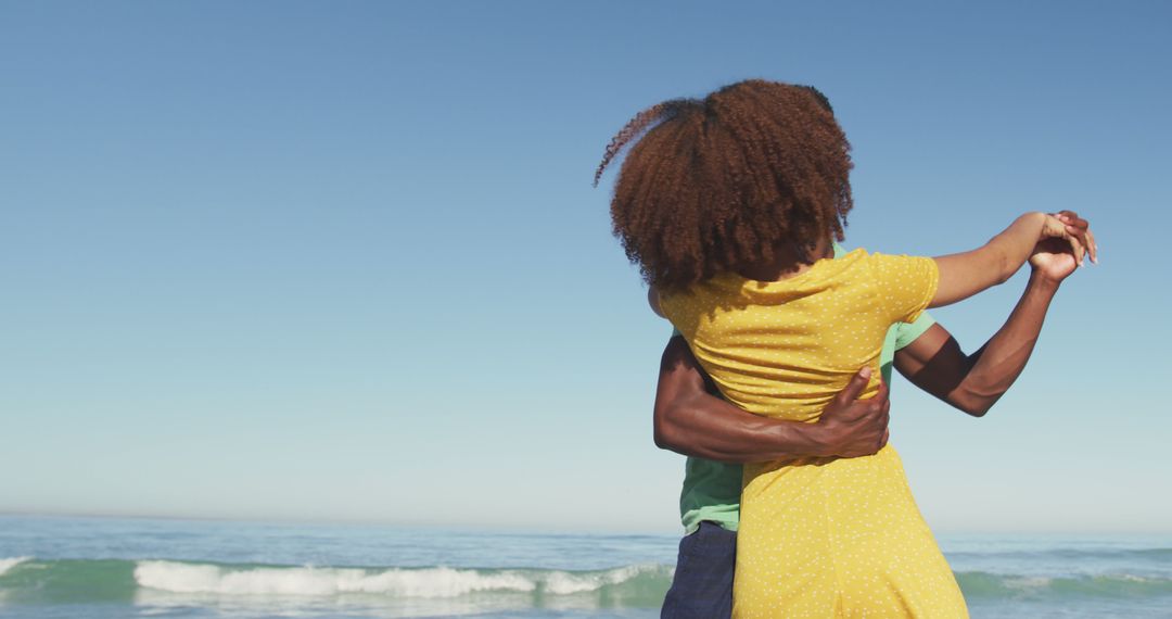 Couple Embracing on Beach with Clear Blue Sky Background - Free Images, Stock Photos and Pictures on Pikwizard.com