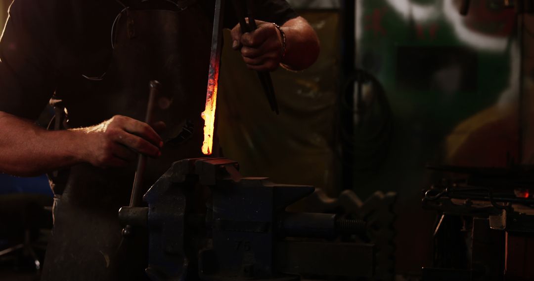 Blacksmith Shaping Heated Metal in Workshop - Free Images, Stock Photos and Pictures on Pikwizard.com