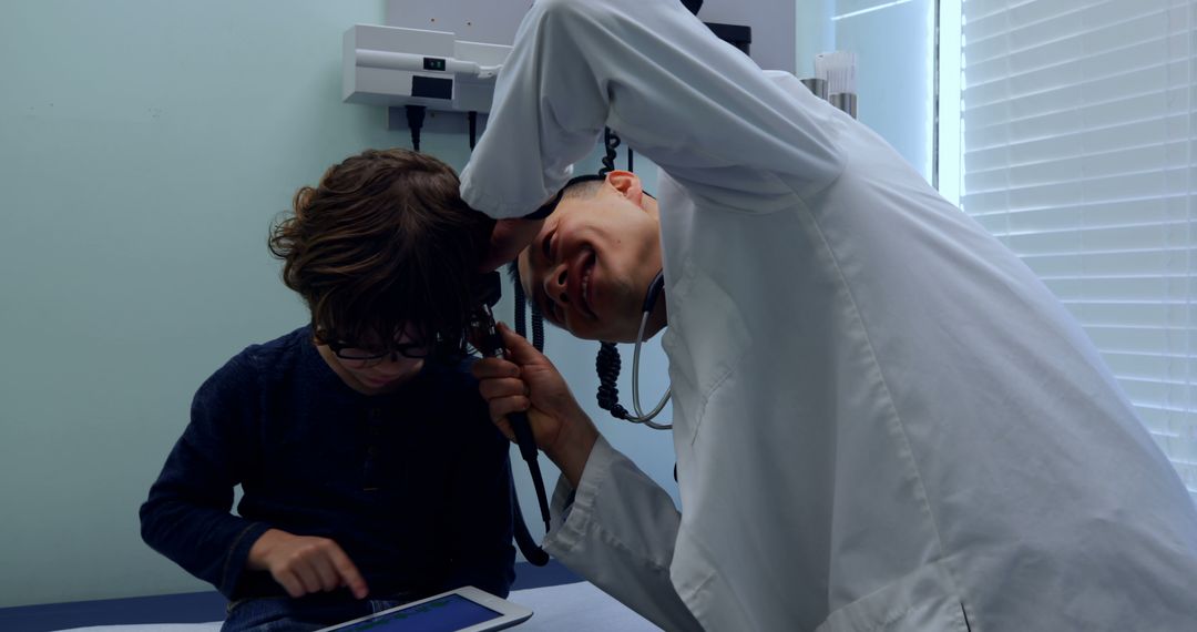 Pediatrician Examining Child's Ear During Medical Checkup - Free Images, Stock Photos and Pictures on Pikwizard.com