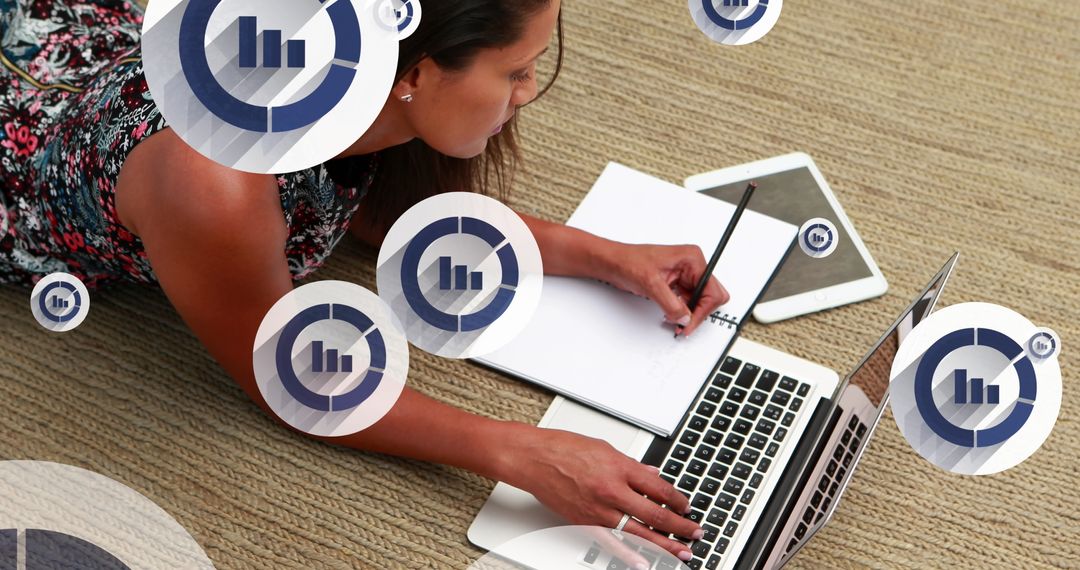 Businesswoman Analyzing Data on Laptop and Notepad