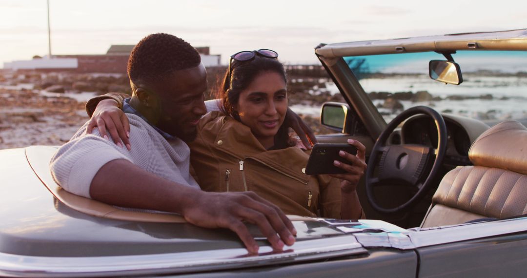 African american couple taking a selfie while sitting in the convertible car on the road - Free Images, Stock Photos and Pictures on Pikwizard.com