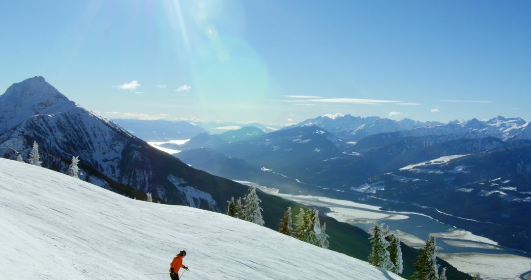 Snowy Mountain Range with Lone Skier in Bright Winter Scene - Free Images, Stock Photos and Pictures on Pikwizard.com