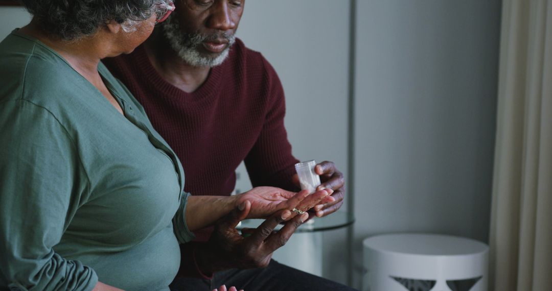 Elderly Man Assisting Wife with Medication at Home - Free Images, Stock Photos and Pictures on Pikwizard.com