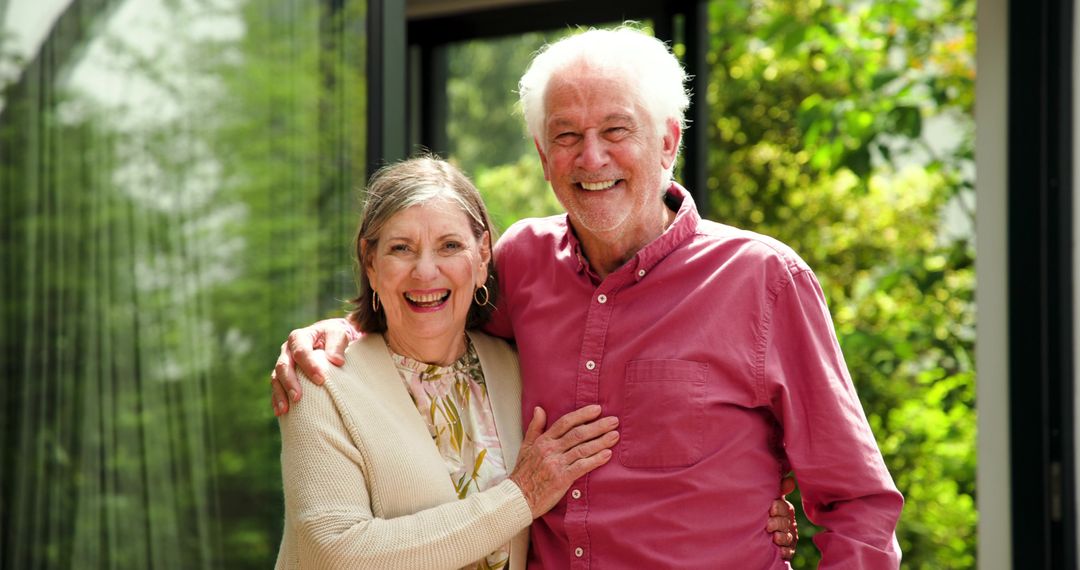Senior Couple Smiling Together at Home Near Lush Garden