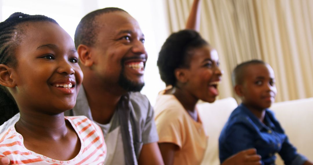 Happy African American Family Watching Television Together at Home - Free Images, Stock Photos and Pictures on Pikwizard.com