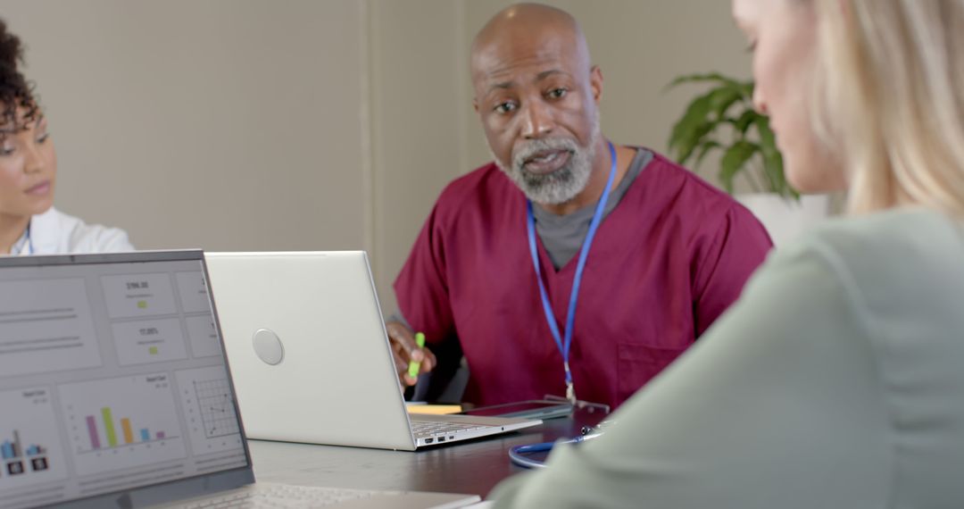 Diverse Medical Team Analyzing Data on Laptops in Meeting Room - Free Images, Stock Photos and Pictures on Pikwizard.com