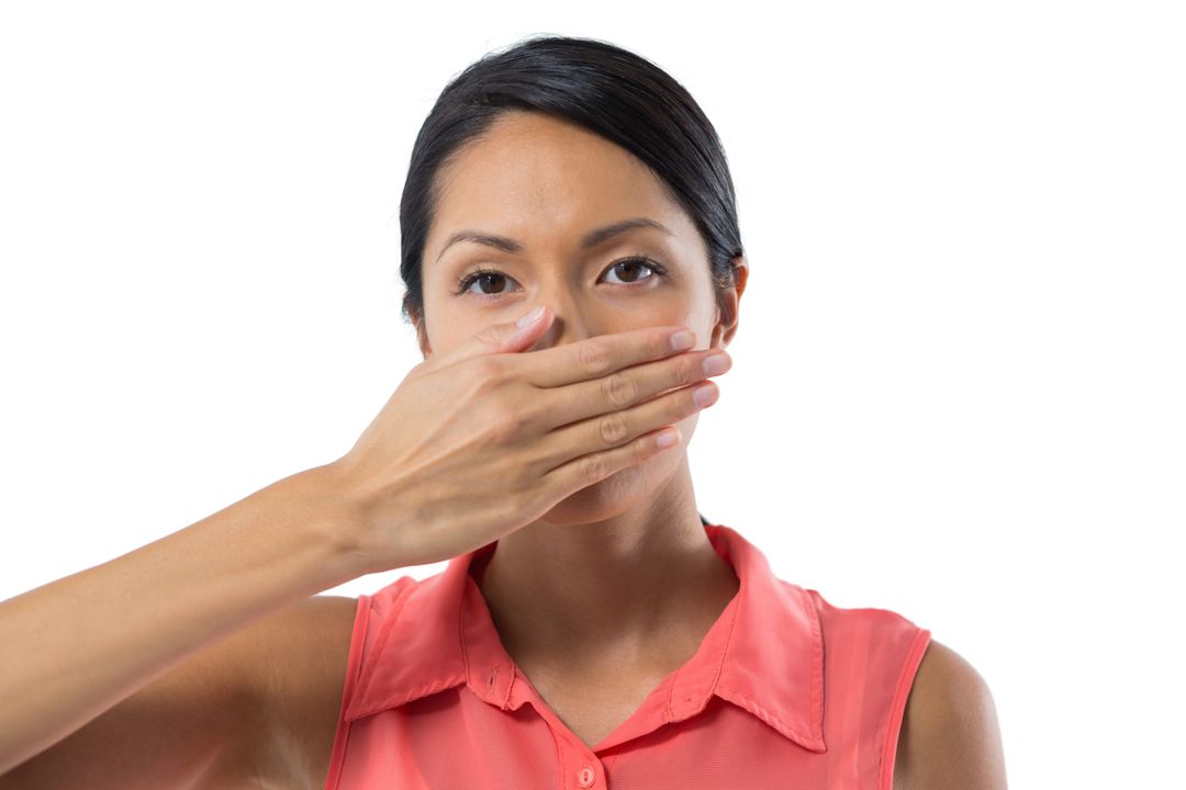 Woman covering her mouth with hand against white background - Free Images, Stock Photos and Pictures on Pikwizard.com