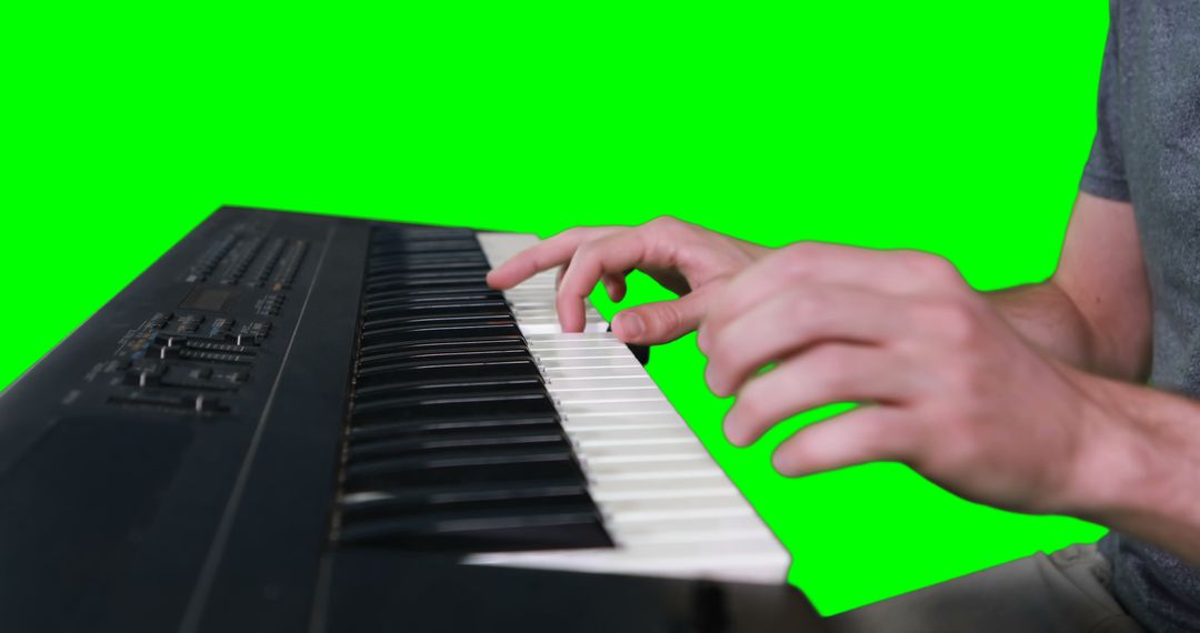 Man Playing Keyboard with Green Background - Free Images, Stock Photos and Pictures on Pikwizard.com