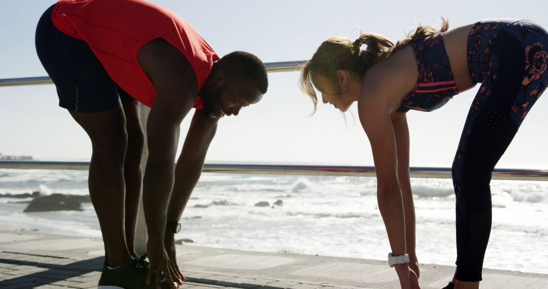 Fit Couple Stretching at Seaside Promenade During Sunrise Workout - Free Images, Stock Photos and Pictures on Pikwizard.com